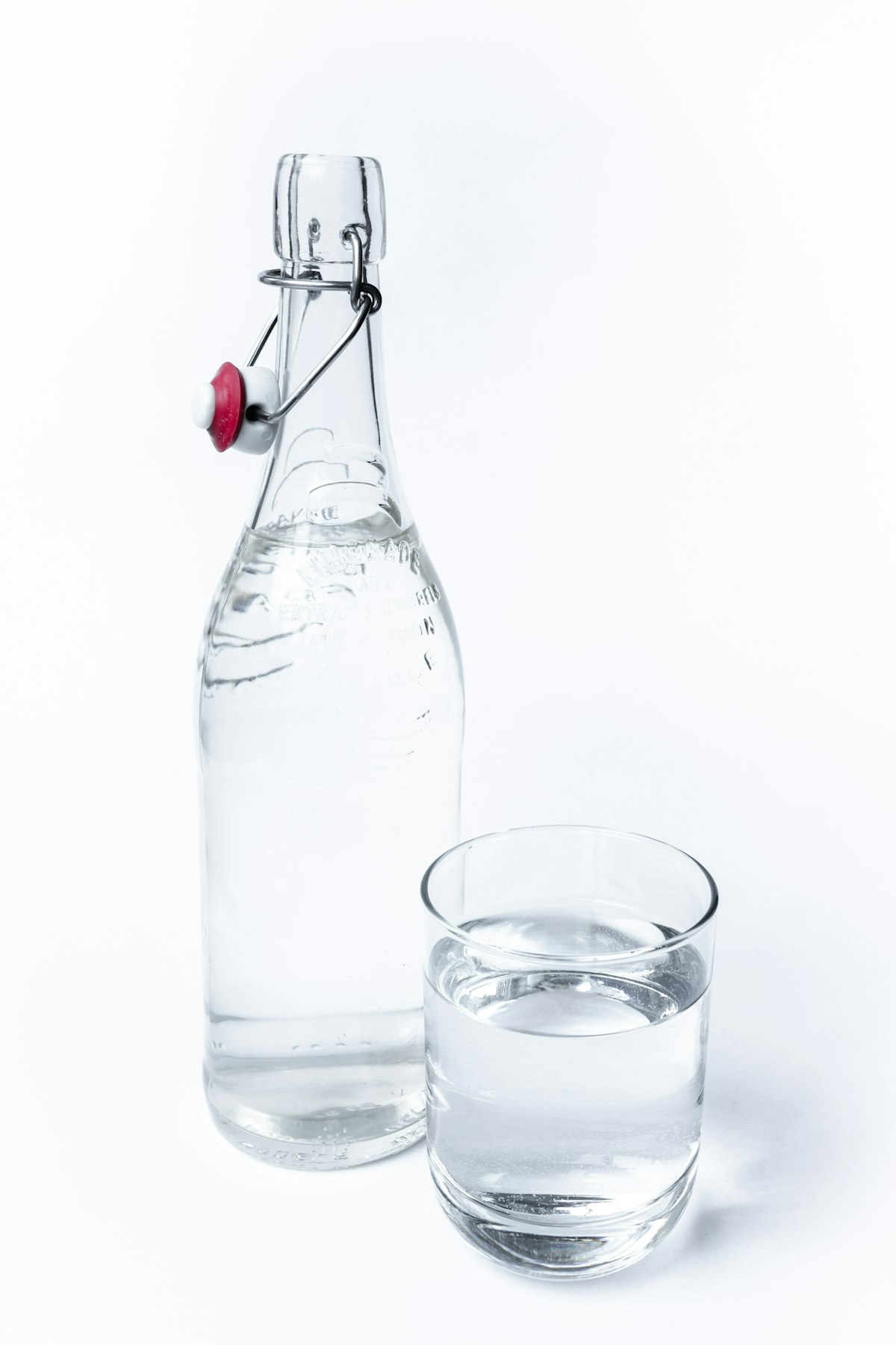 A clear glass carafe with a tumbler on top