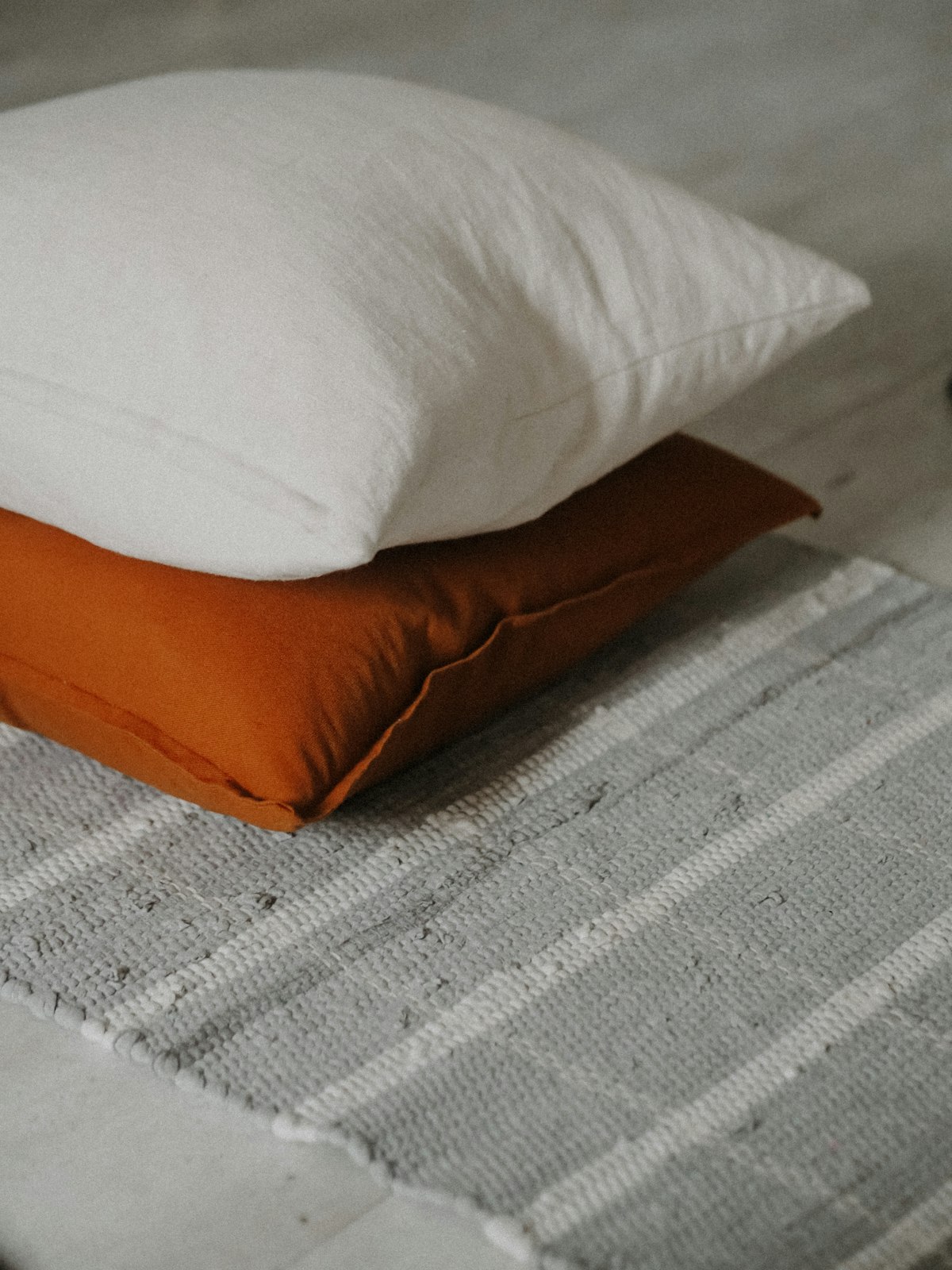 A large square floor cushion in natural cotton