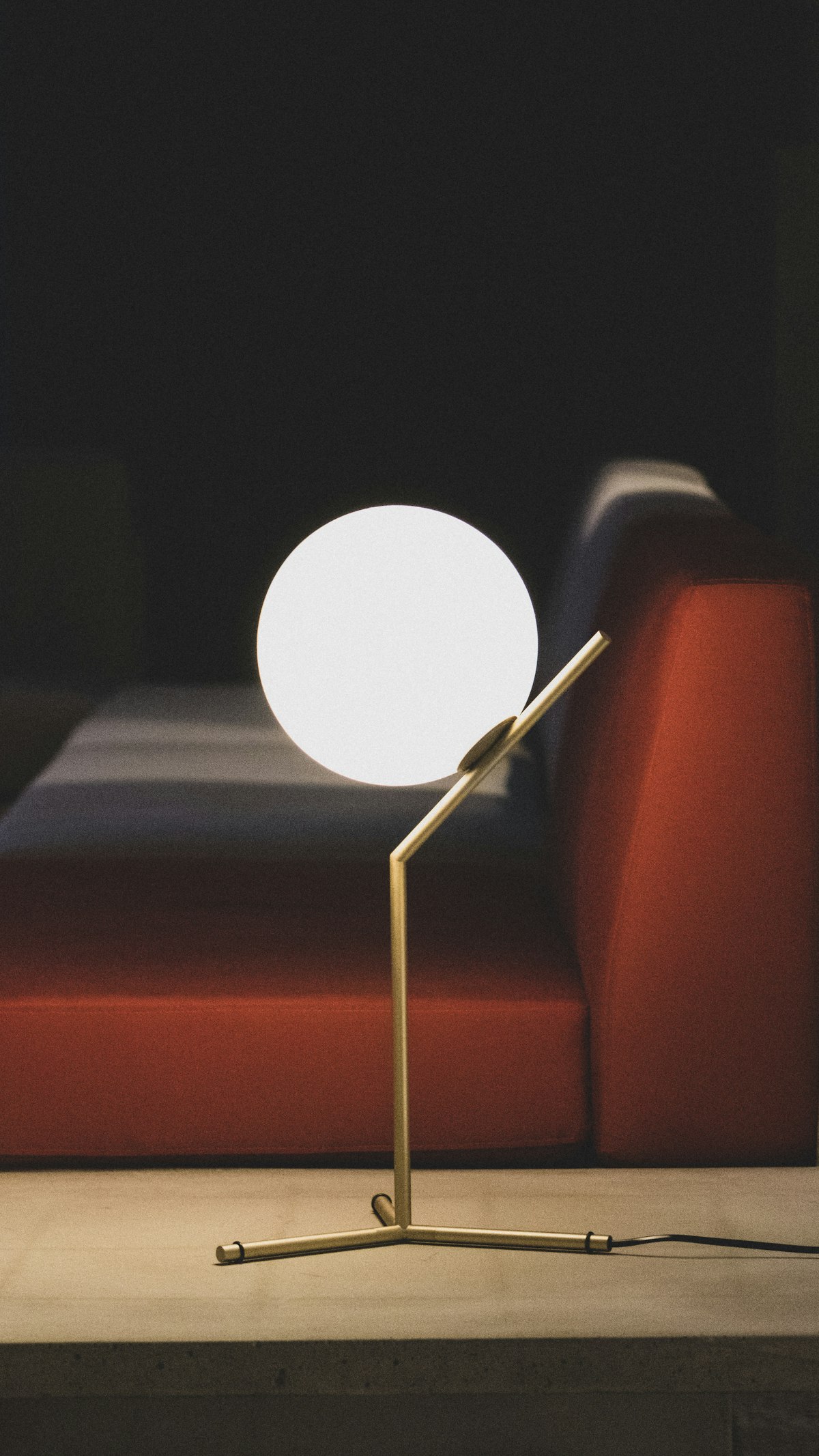 A table lamp with an alabaster globe on a brass stem