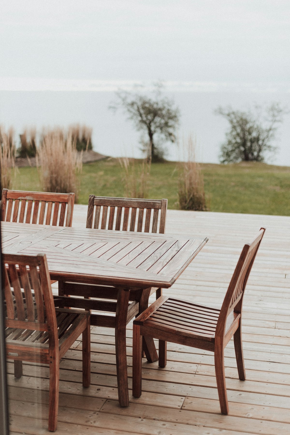 A teak outdoor dining table with four chairs